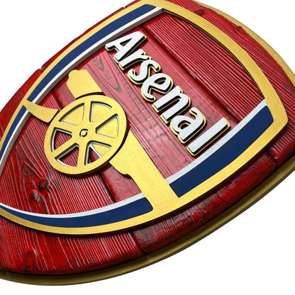 Close up of layered Arsenal wood sign with raised lettering and cannon detail