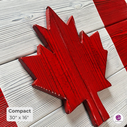 Close-up of compact Canadian wood flag showing detailed charred cedar grain and texture