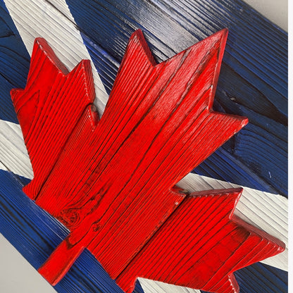 Close up Scottish Canadian wood flag showing raised maple leaf detail