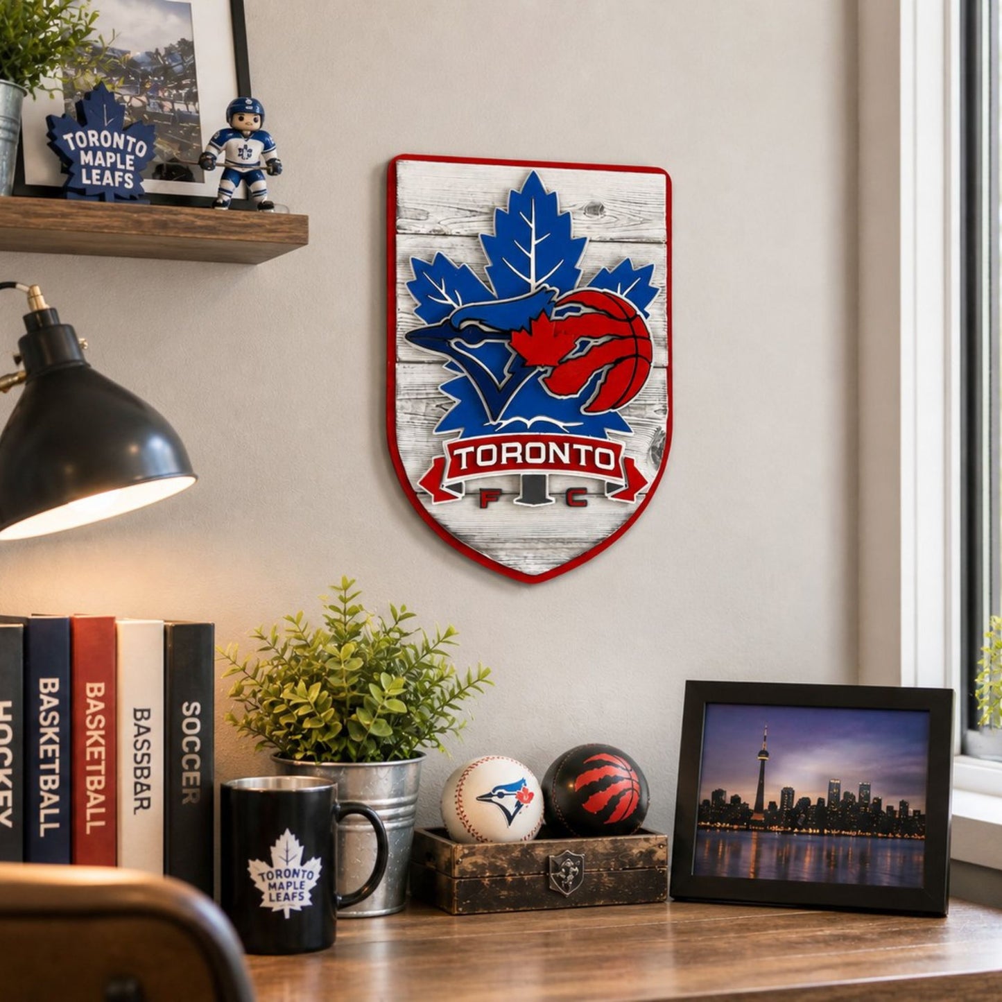 Toronto sports wood sign featuring Blue Jays Raptors Maple Leafs and TFC wall art. On wall above a desk